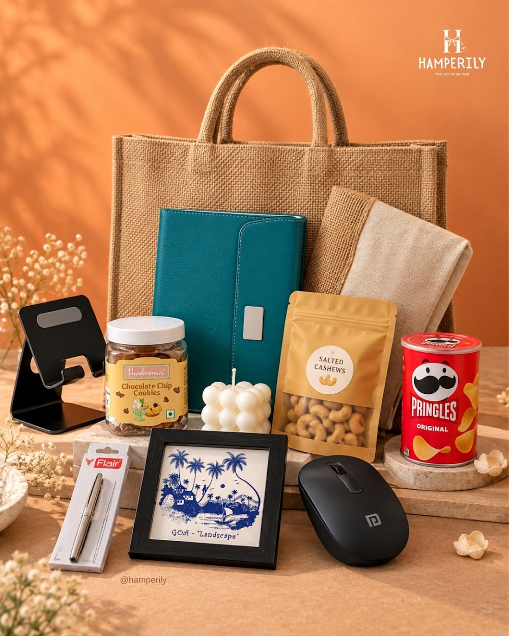 Corporate desk hamper in a jute bag with mouse, phone stand and snacks