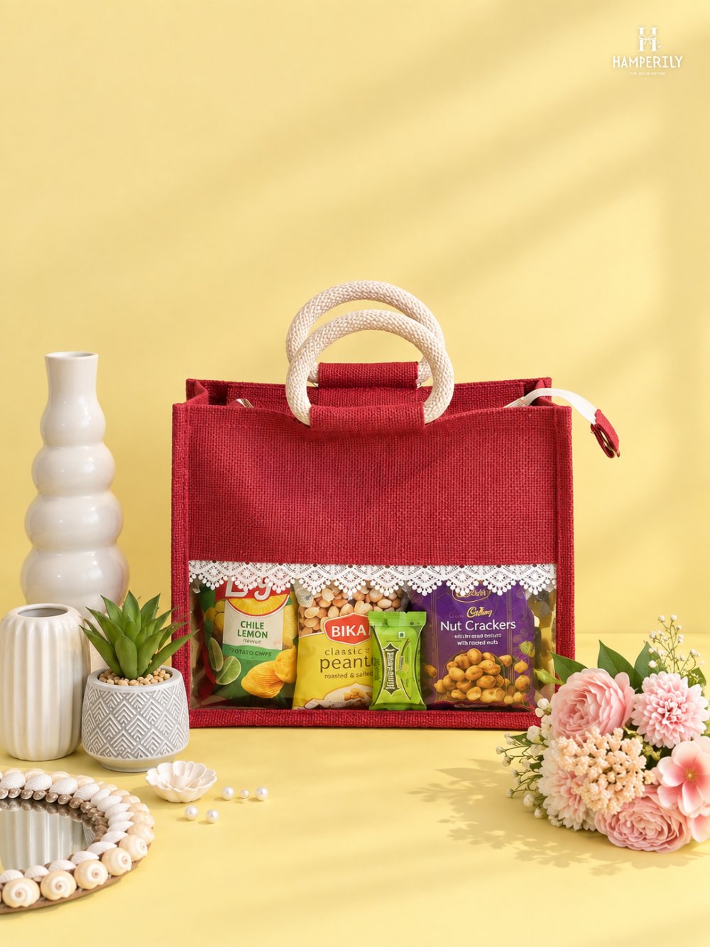 Red jute bag hamper with snacks